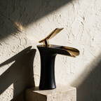 The mixer alone on a travertine plinth against a textured plaster wall in raking sunlight.