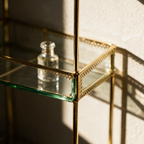 Macro view of a glass tier seated into its slim gold upright.