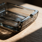 Macro view of one corner of the tray where the raised lip meets the thick glass base.