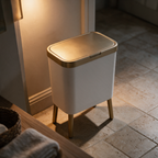 Downward view of the brass push-top lid and the top of the white drum.