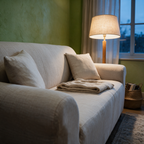 Side profile of the covered sofa at dusk showing the cover wrapping the arm and back in one surface.