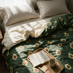 Overhead view of the avocado quilt across a made bed with the corner turned back.