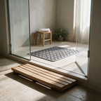 Low floor-level view across a bathroom with the mat lying flat in the shower base.