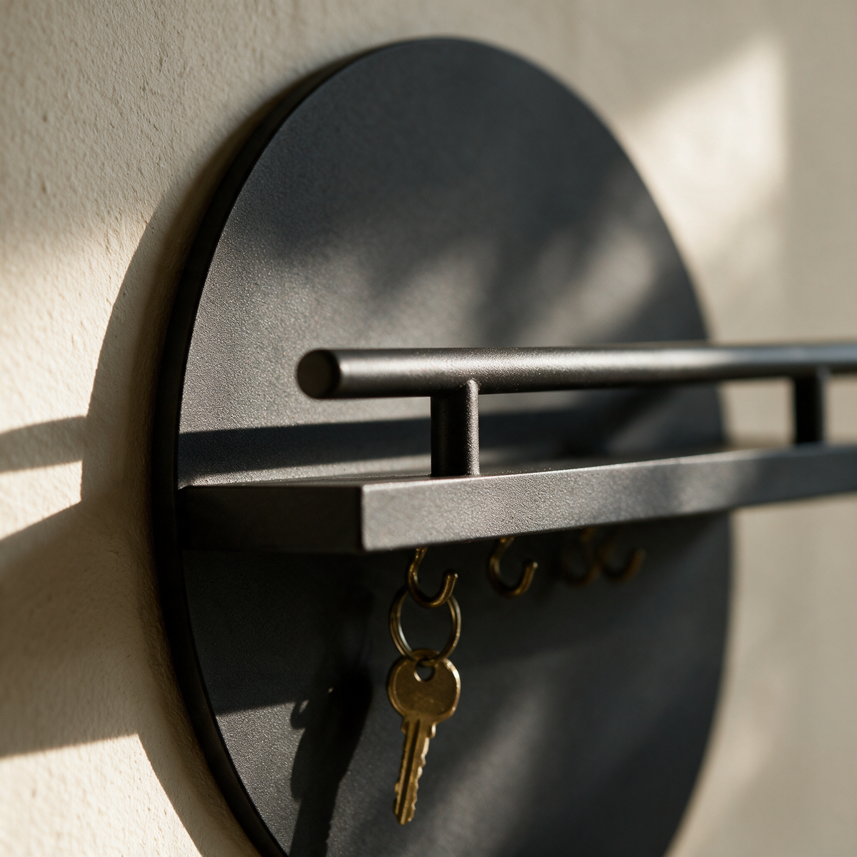 Close view of the shelf meeting the round disc with a brass key hanging from a hook below.