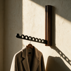 Harlow folding timber wall rail with a wool coat on the notched arm