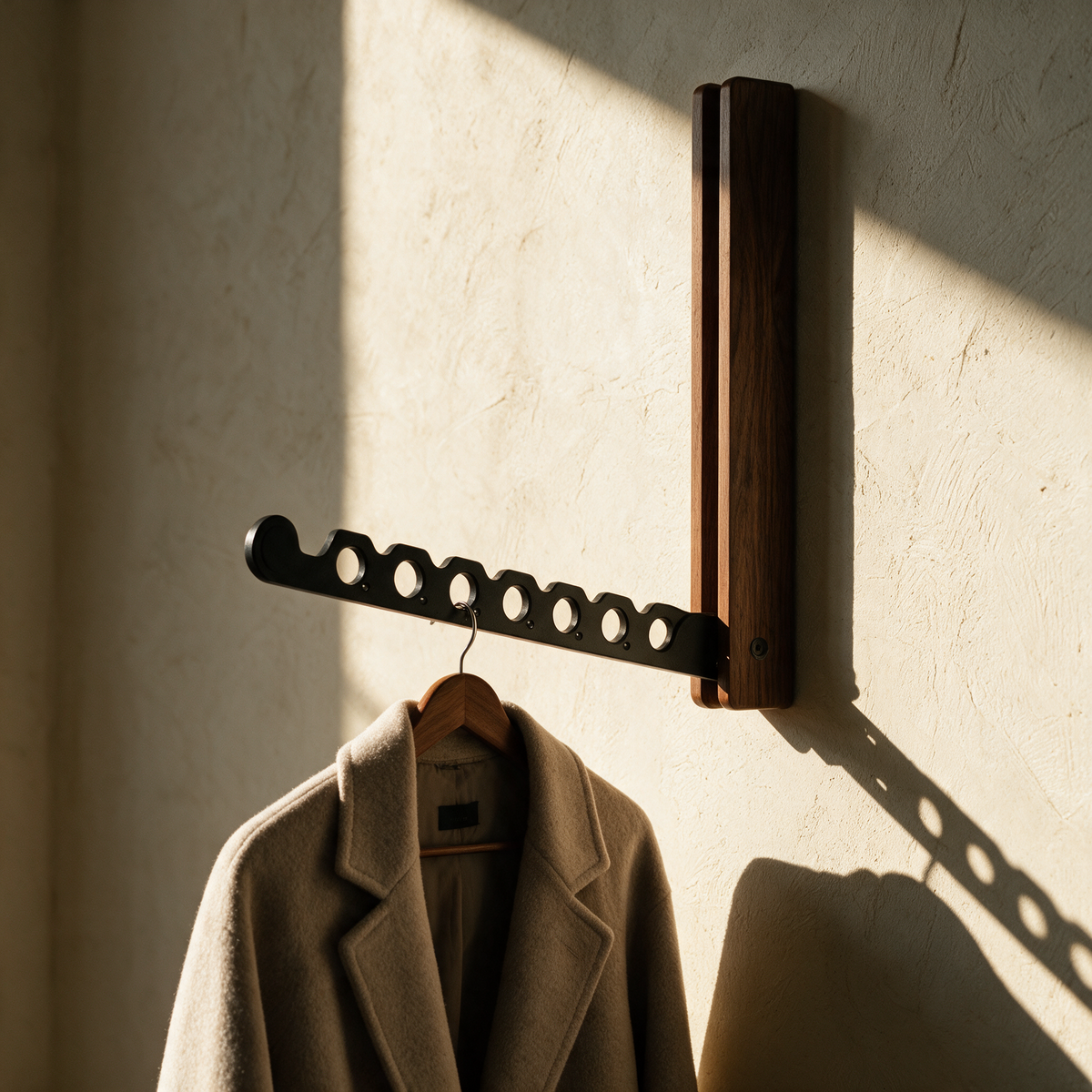 Harlow folding timber wall rail with a wool coat on the notched arm