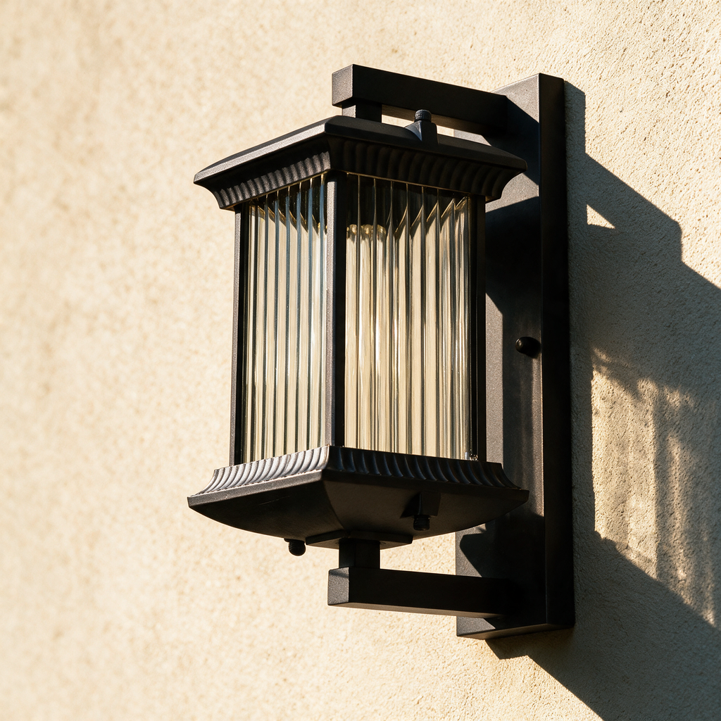 Thornbury outdoor lantern on a render wall in raking sunlight