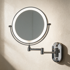 Solace swing-arm mirror lit, arm extended, against a warm plaster wall