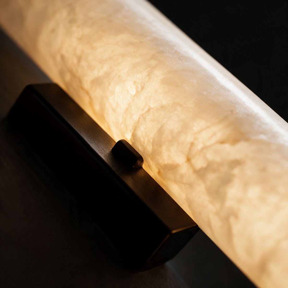 Close-up of the veined alabaster shade meeting the black bracket