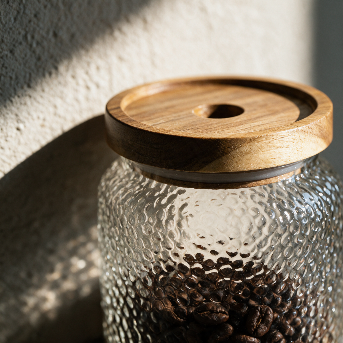 Close-up of the dimpled glass meeting the acacia lid