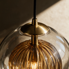 Close-up of the brass collar meeting the glass shade