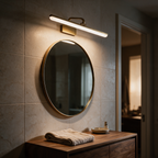 Laurel brass vanity light above a round bathroom mirror