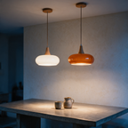White and orange Rowan pendants side by side over a dining table