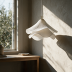 Halcyon pendant unlit beside a window, pleats in raking light