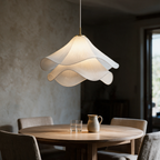 Halcyon pendant lit above a round oak dining table