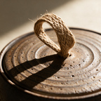 Close-up of the knotted hemp loop on the lid