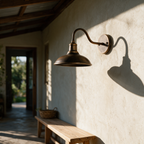 Barrow barn light on a rendered wall beside a terrace