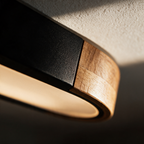 Close-up of the matte black body meeting the solid timber end cap