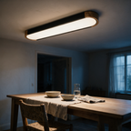 Tamar black oval ceiling light with timber ends lit above a dining table