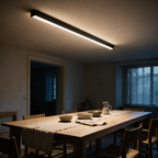Mistral linear LED bar lit above a long dining table at dusk