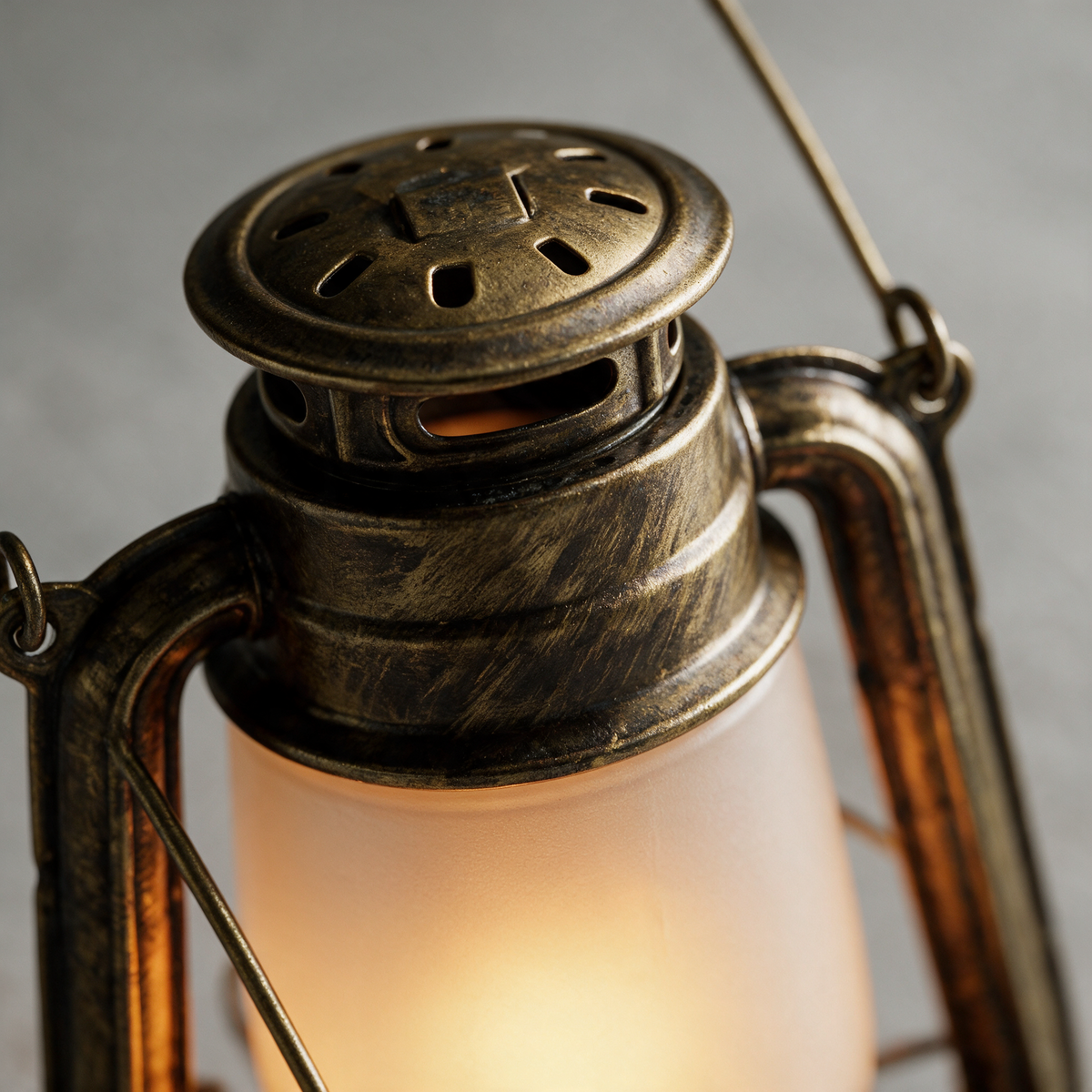 Close-up of the domed vented cap and aged brass patina