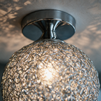 Close detail of the aluminium wire dome and chrome canopy
