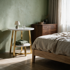 Low view of the two-tier side table beside a bed with a lamp and books on its shelf