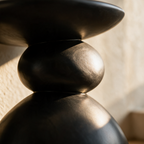 Close-up of the crease where two matte black pebble forms meet in the stack