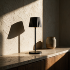 Unlit table lamp on a travertine sideboard with raking sunlight picking out the fluted shade.