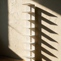 The empty white spine bookshelf on a plaster wall showing its staggered shelf plates