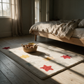Cream rug scattered with coloured stars on the floor of a child's bedroom in late afternoon light.