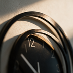 Close-up of the sculpted frame overlapping itself at the edge of the black dial