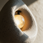 Macro close-up of the speckled resin rim meeting the smooth glowing glass globe inside the hollow.