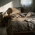 Tan and black leopard print duvet and matching pillowcases dressed on a low oak bed.