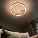 Looking up from a sofa at the glowing ring overhead with the arc curving away.