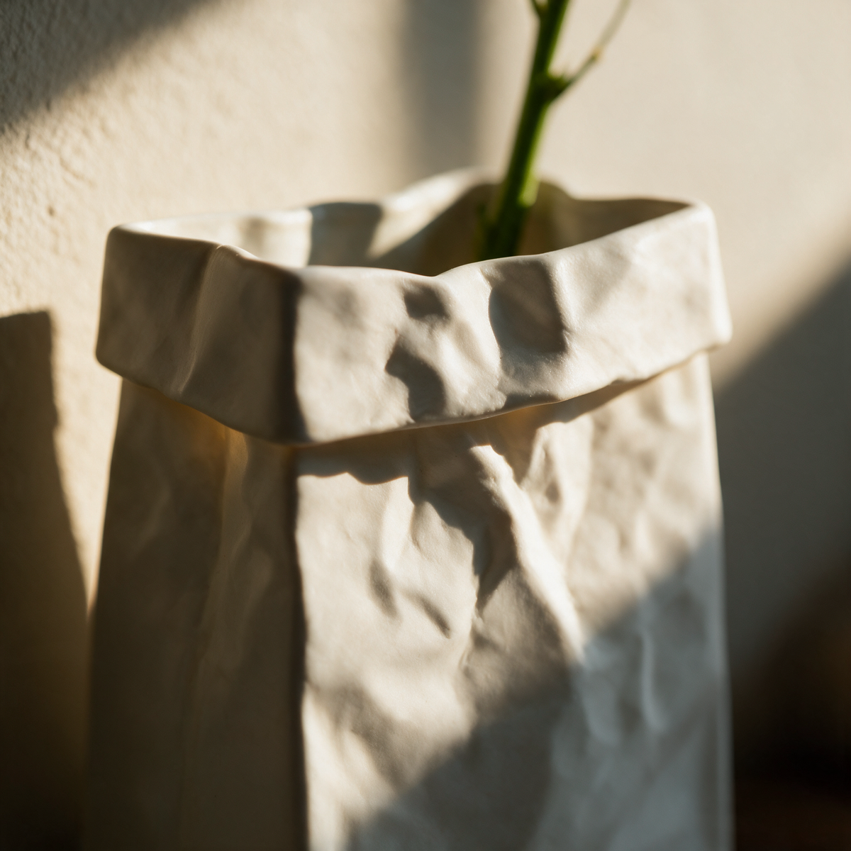 Close-up of the folded-over top edge of the ceramic vase