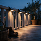 Four clamp lights spaced along a balcony rail casting repeating pools of light.