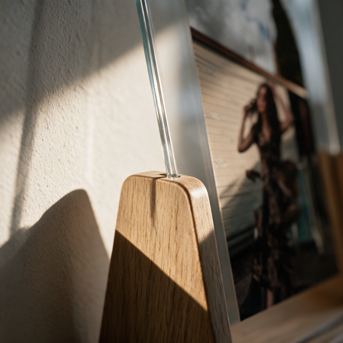 Close-up of the pivot where the acrylic panel meets the timber cradle arm
