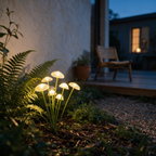 Cluster of solar mushroom lights glowing amber among ferns at dusk.
