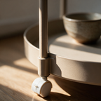 Close-up of the vertical handle where it joins the rim of the top tier.