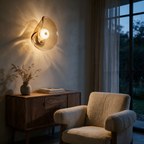 Amber art glass wall light glowing above a walnut sideboard in a living room at dusk.