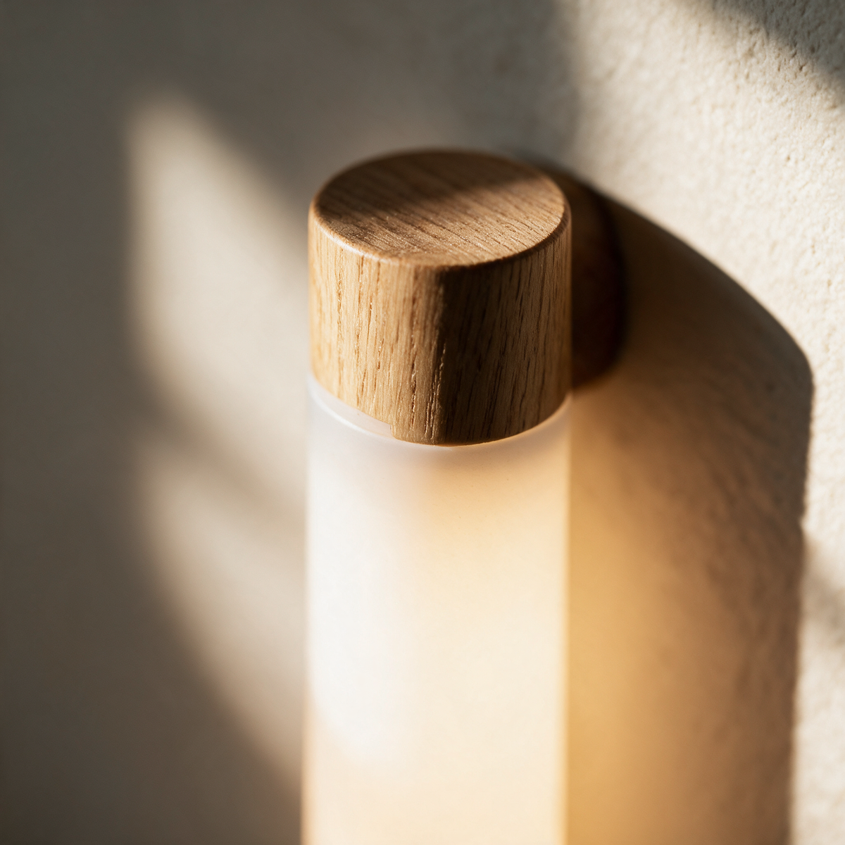 Macro close-up of the seam where the timber cap meets the glowing white opal tube.